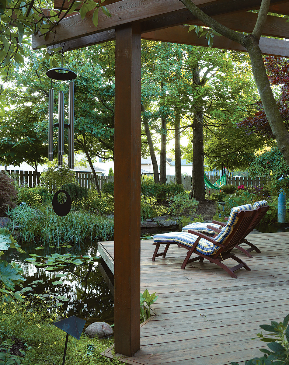 deck in a backyard over garden pond