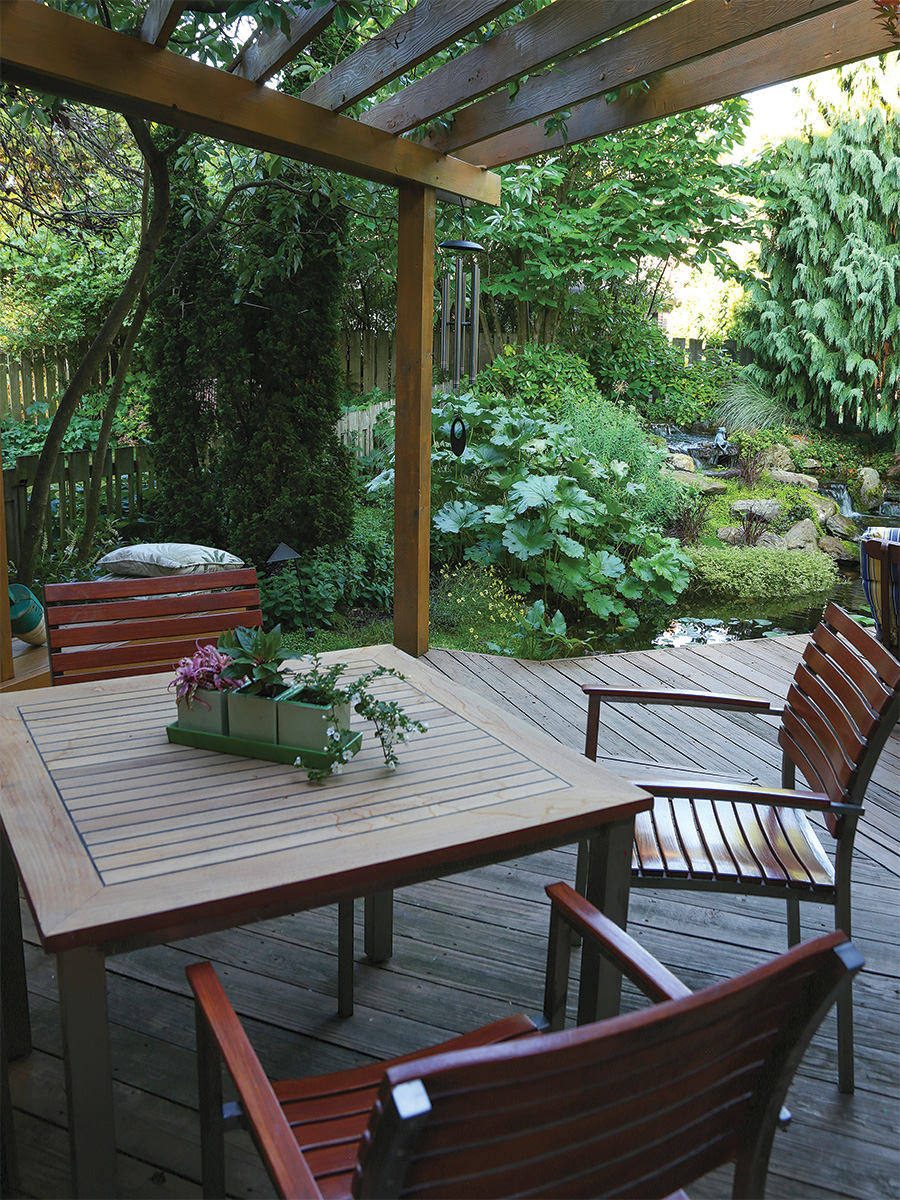 patio table and chair under a pergola
